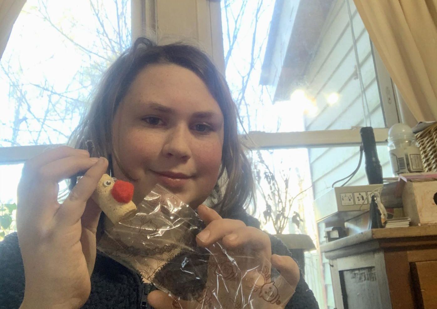 girl with handmade reindeer ornament