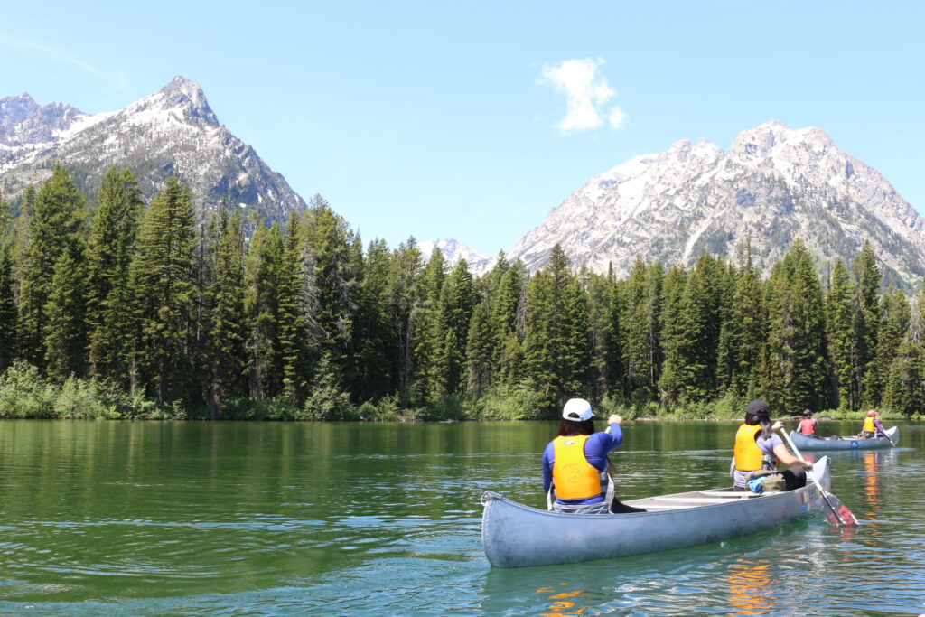 youth canoeing on lake in Grand Teton National Park
