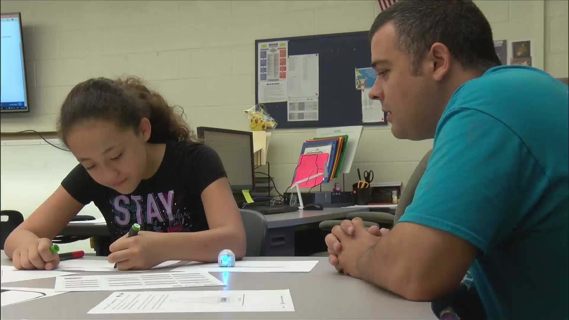 Javier Reyes, teacher at Monmouth Central Intermediate School, working with a student