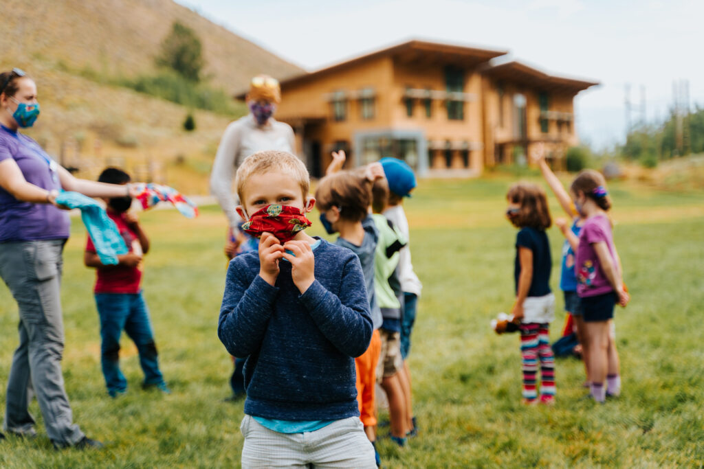 kids playing outside wearing face masks