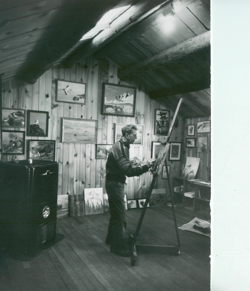 Olaus Murie painting at an easel in his studio, surrounded by wildlife artwork